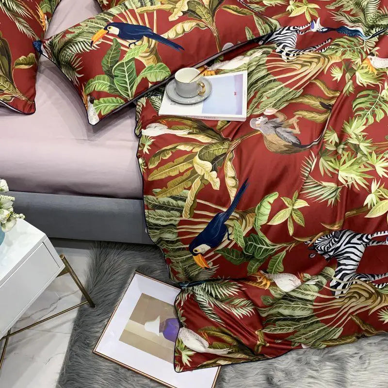 Unmade bed featuring the Elysian Garden Bedding Set, showcasing a beautifully printed duvet cover with exotic birds and leaves, paired with coordinating pillows for a serene and luxurious bedroom look.