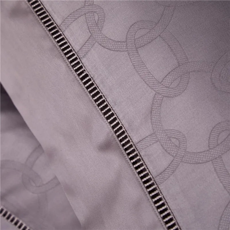 Close-up of the flat sheet from the Grand 4-Piece Jacquard Bedding Set in purple, showcasing the intricate Jacquard weave crafted from 1000-thread count Egyptian cotton. The luxurious texture and elegant design highlight the softness and silky feel of the fabric, adding refined sophistication to the bedding set. This detailed shot emphasizes the set’s ability to elevate any luxury bedroom, creating a serene, opulent atmosphere for ultimate comfort and style.