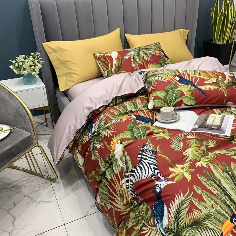 Reversible duvet from the Elysian Garden Bedding Set, featuring a printed top with exotic birds and leaves, and a solid gray underside, offering versatility and luxury for your bedroom decor.