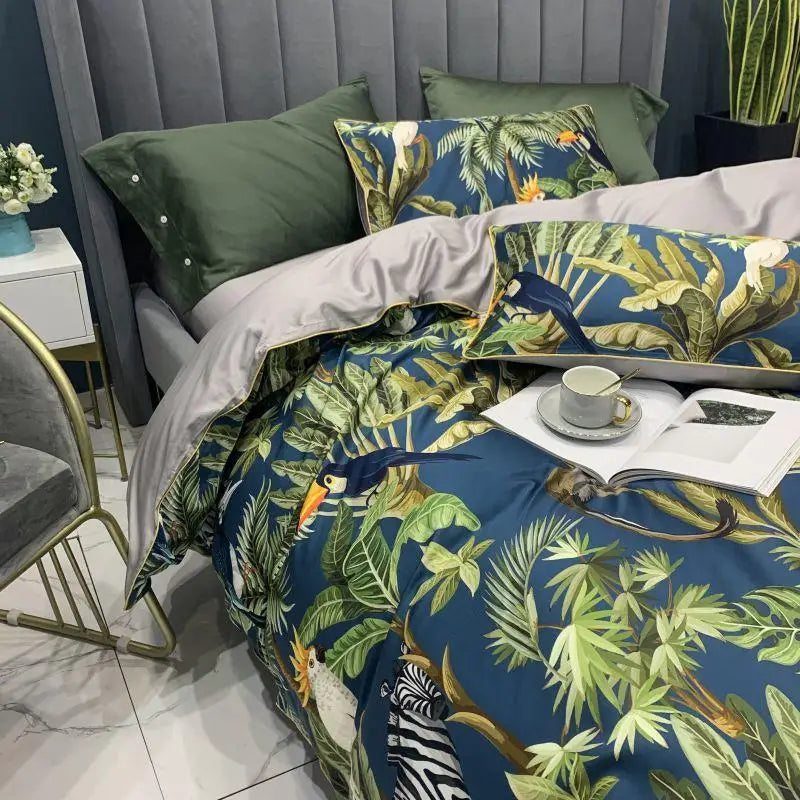 Reversible Royal Garden duvet featuring a printed exotic bird and leaf design on one side and a solid gray color on the other, crafted from luxurious Silky Egyptian Cotton for ultimate comfort and elegance.