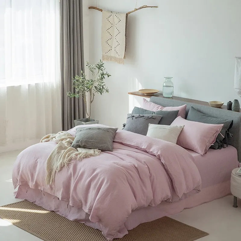 Side view of Linené French Linen Duvet Set in Rose Color, highlighting the premium bedding with neatly arranged duvet, pillowcases, and bed sheet.