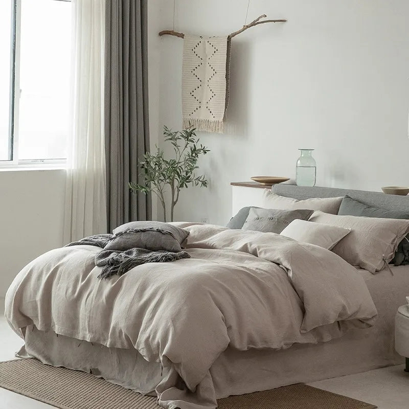 3/4 view of Normelle French Linen Bedding Set in beige, elegantly arranged on the bed, showcasing the duvet cover, pillowcases, and luxurious linen texture.