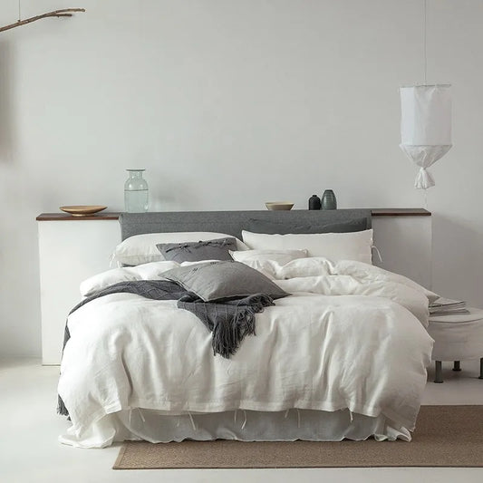 Normandie French Linen Bedding Set in white, beautifully arranged on a bed, showcasing the duvet cover, pillowcases, and luxurious linen texture.