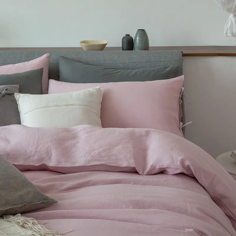 Close-up of Linené French Linen Duvet Set in Rose Color, focusing on the luxurious texture of the duvet cover and pillowcases, showcasing fine linen details.