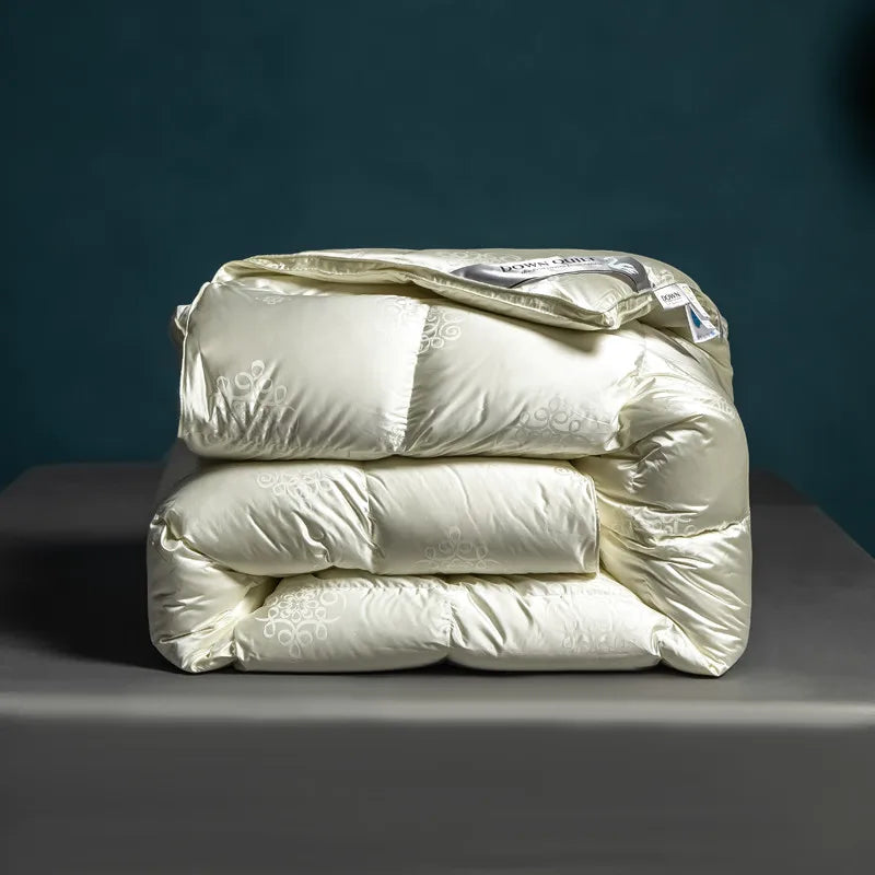 Luxurious goose down comforter with 100% cotton cover, silky jacquard texture, bread shape design, and reversible styling for year-round comfort