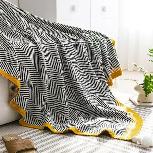 Close-up of the Nordic Throw’s soft, knitted fabric, highlighting the cozy texture and intricate diagonal stripes.