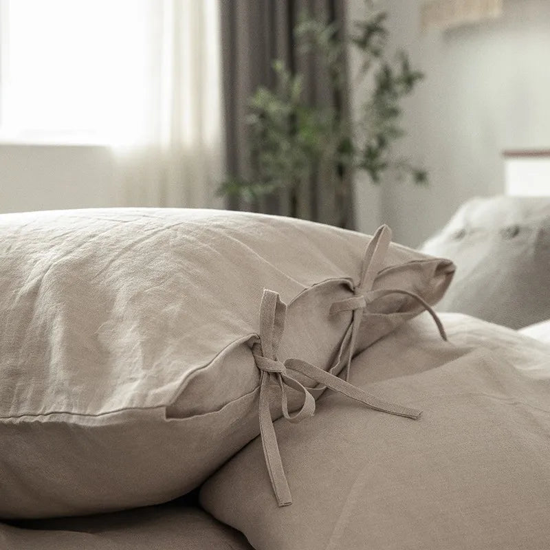 Close-up of Normelle French Linen pillowcase in beige, showcasing the neat pillow closing with fine stitching and the soft, luxurious linen texture.