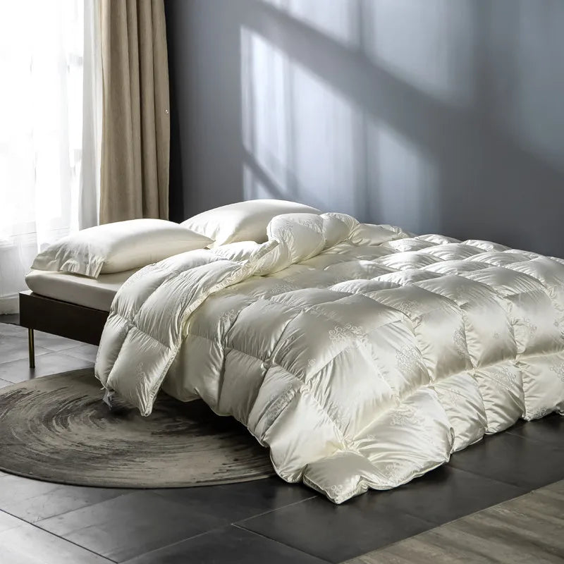 Luxurious goose down comforter with 100% cotton cover, silky jacquard texture, bread shape design, and reversible styling for year-round comfort