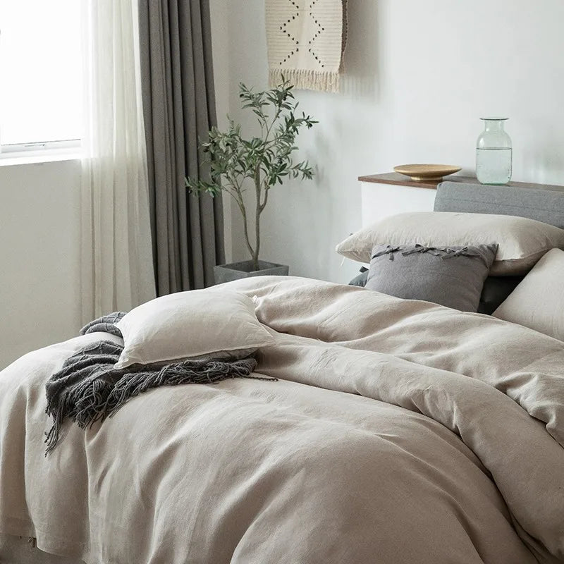 Close-up side view of Normelle French Linen Bedding Set in beige, showcasing the soft, luxurious linen texture and fine details of the duvet cover and pillowcases.