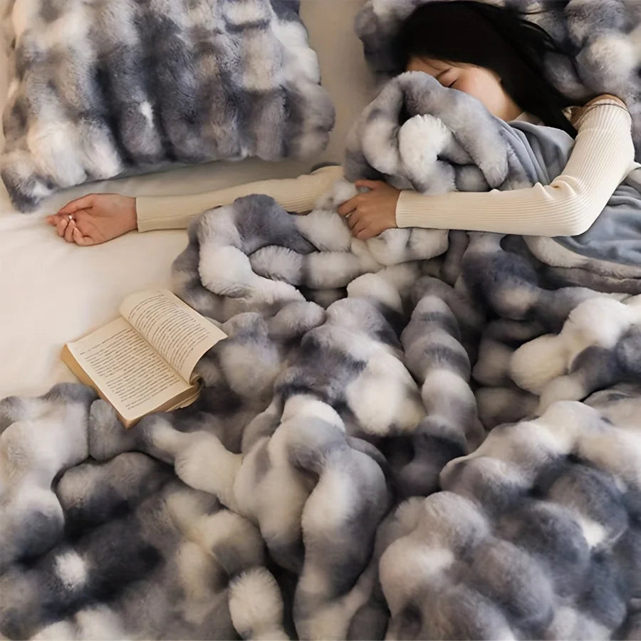 Girl sleeping under Dream Faux Fur Tie-Dye Blanket in grey/blue and white colors. This ultra-soft, luxurious throw from our French-Style collection adds elegance and comfort to any space. Perfect for the bed, sofa, or office, it combines style and warmth for year-round relaxation.