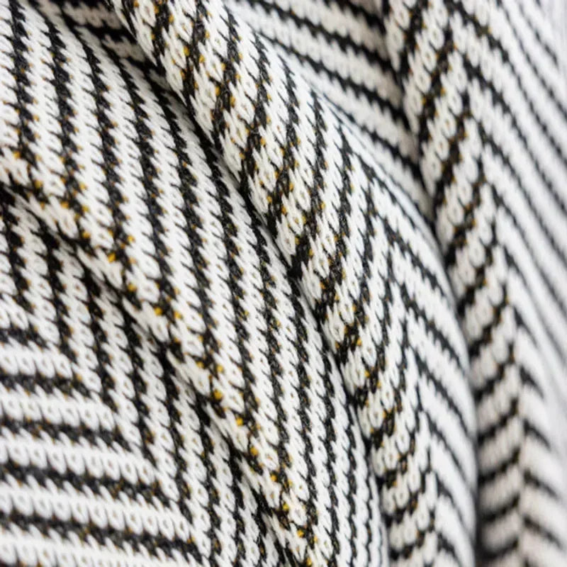 Detailed close-up of the Nordic Throw's cozy knitted fabric, highlighting the softness and texture of the blanket.